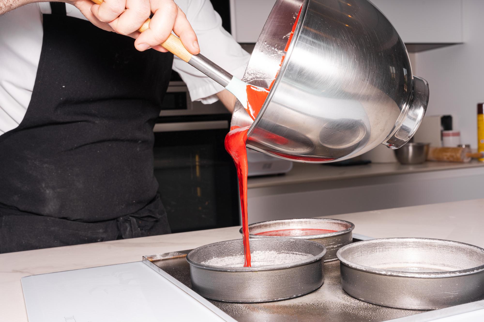 Kucharz przygotowujący sos redukcyjny nad płytą kuchenną